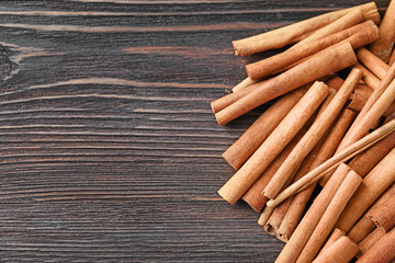 Aromatic cinnamon sticks on wooden background