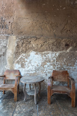 Old Chinese traditional table set with grungy wall