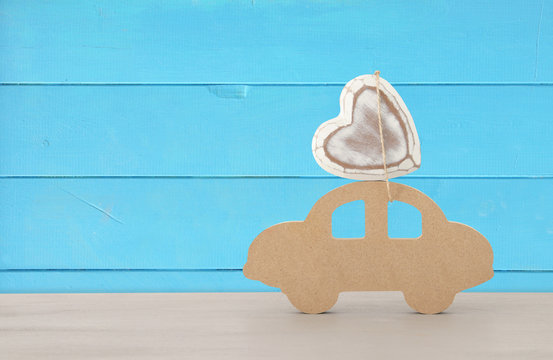 Image of wooden car with heart on the roof, present for dad. Father's day concept.