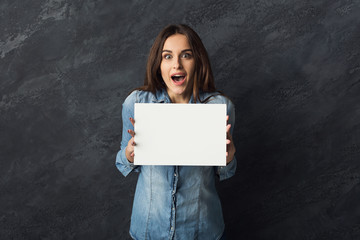 Young woman holding blank white banner