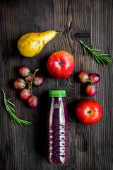 fitness smoothie in plastic bottle on wooden table top view mock