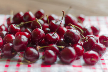 fresh, ripe, jfresh, ripe, juicy cherries lying on the table, selective focus, shallow depth of fielduicy cherries lying on the table, selective focus, shallow depth of field