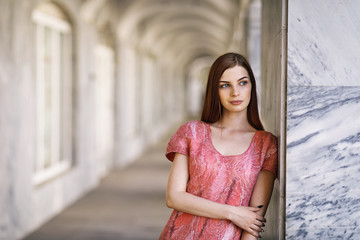 Portrait of a young stylish girl in a pink dress handmade with space for text