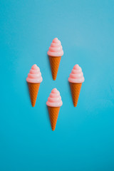 plastic ice cream in cones pattern on blue background