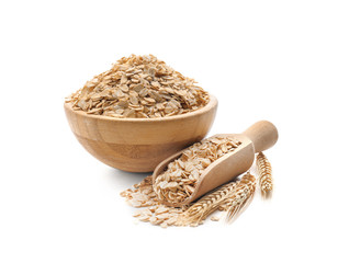 Bowl and scoop with raw oatmeal on white background