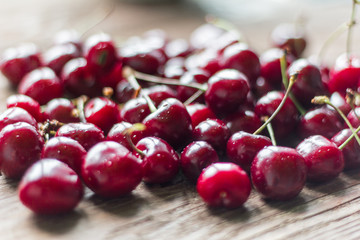 fresh, ripe, juicy cherries on wooden background with shallow depth of field, selective focus