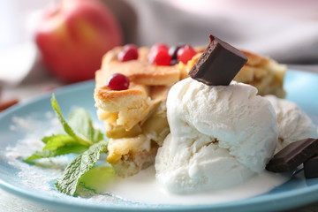 Plate with piece of delicious apple pie and ice cream on table, closeup
