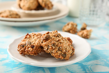 Plate with delicious oatmeal cookies on table