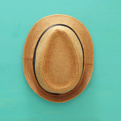 Top view of male fedora hat over wooden background.