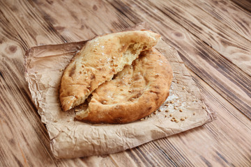 Fresh tasty pita bread on wooden table