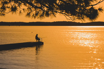 fisherman on the jetty at sea