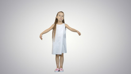Young lady is dressed up in lovely dress and white shoes singing a song on white background