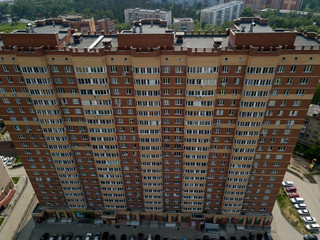 Aerial view of newone skyscraper in the city with parking cars. Russian streets, Novosibirsk.