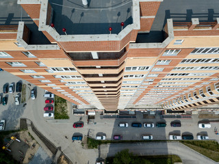 Fototapeta premium Aerial View of one entrance to skyscraper with parking cars in the city. Dachnaya street, Novosibirsk.