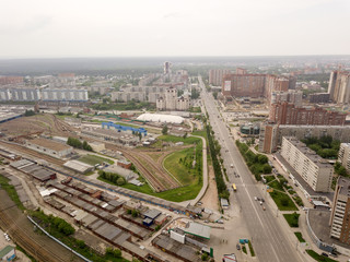 Fototapeta na wymiar Aerial view of old and new russian buildings with rails and river in the city with a lot of cars. Russian streets, Novosibirsk.