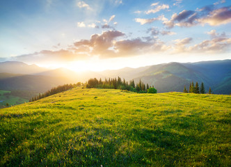 Sunset in the mountain valley. Beautiful natural landscape in the summer time - obrazy, fototapety, plakaty