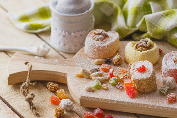 Eastern sweets with fruits, nuts and sugar powder