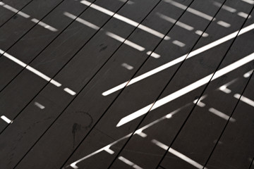 Strips of sunrays on a wooden floor, unusual abstract background design.