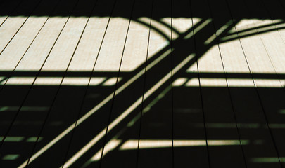 Strips of sunrays on a wooden floor, unusual abstract background design.