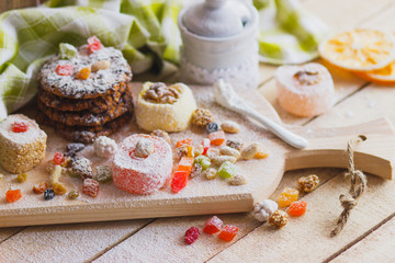 Eastern sweets with fruits, nuts and sugar powder
