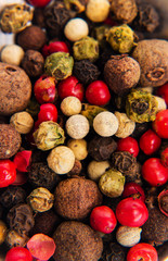 View from the top of dried red, black and white peppercorns