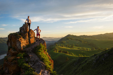 Happy man and woman on top mountain in Altai, sunset light, beauty summer landcape