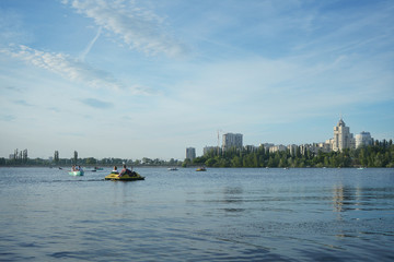 Naklejka premium Walking on a catamaran on a river in the city on a clear day.