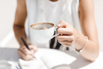 A Woman Drinking Coffee Outdoors