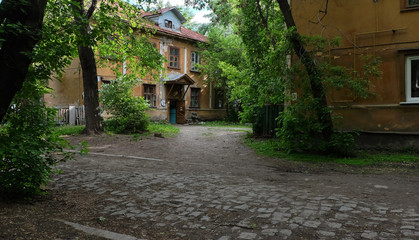 old city courtyard among green trees