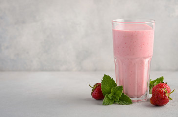 Strawberry milkshake on a gray concrete background, selective focus, copy space.