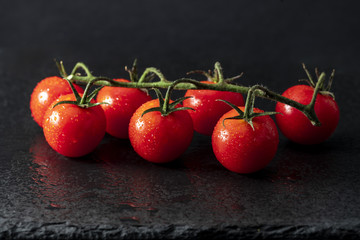 Fresh Tomatoes on black slate