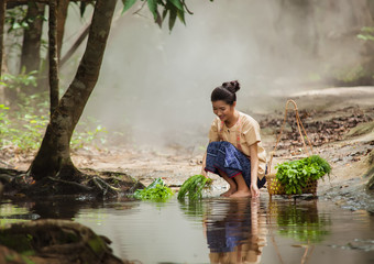 Asian woman wearing traditional Thai culture at the forest.Daily life of rural women in Thailand,Asia people at farmland.