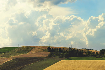 Countryside landscape, cultivated fields and cloudy sky