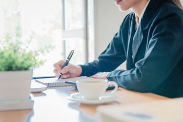 Close-up Working process startup.Modern notebook on table. Holding hands with pen over document