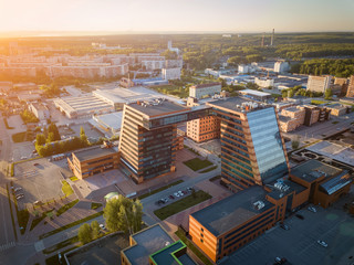 Aerial view of academpark technopark of the Novosibirsk Academic Township -  a large building with laboratories and innovative projects, inventions of a technical charactere at sunset on a sunny day