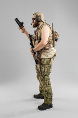 Special forces soldier with rifle on white background.