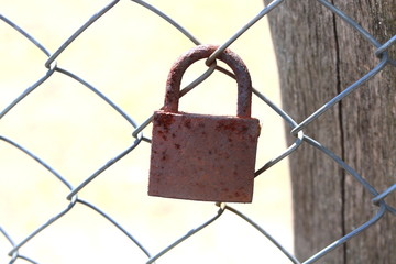 old rusty padlock on an iron fence close-up