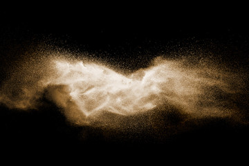 Fototapeta na wymiar Brown particles splattered on black background.
