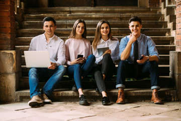 group of students or teenagers with laptop and tablet pc computers at park or campus