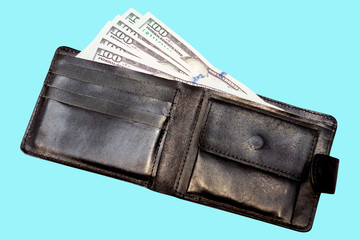 Black leather wallet with dollars on a blue insulated background_