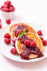 pancake with fresh raspberries and raspberry sauce