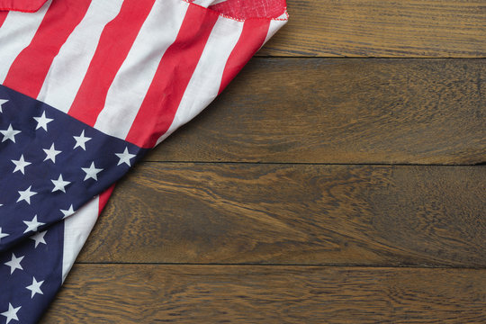 Table top view 4 th July independence day holiday background concept.Flat lay USA flag for sign of season on modern rustic brown wooden at office desk.Free space for creative design text & content.