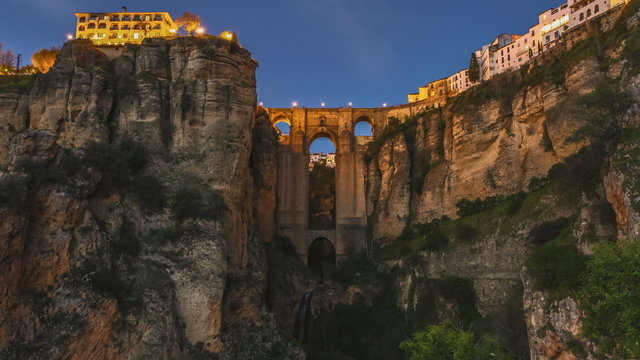 Day and dusk to night   of the popular historic landmark of spectacular Puente Nuevo, New Bridge at sunset, over Guadalevin River in Ronda town, Andalusia, Spain.