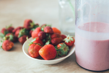 Preparing a smoothie of strawberries