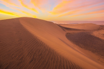 Fototapeta na wymiar Famous natural park Maspalomas dunes in Gran Canaria at sunrise, Canary island, Spain