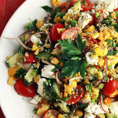 Colorful vegetable mix. Simple low calories salad. Cherry tomatoes, sweet corn, cucumber, bell pepper and cottage cheese. Weight loss dish. European cuisine. Top view. Toned photo.
