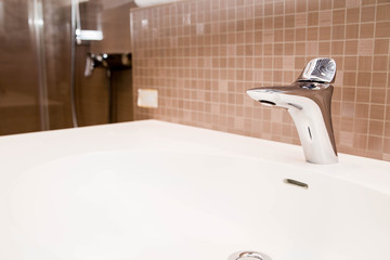 ceramic tiles, faucet and sink in the bathroom