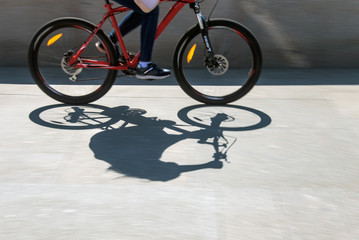 Fototapeta na wymiar Defocused cyclist silhouette