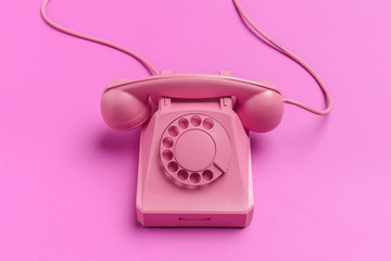 vintage phone on color background