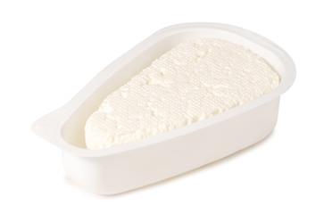 Fototapeta na wymiar Cottage cheese in a plastic container on a white background isolation